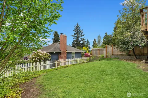 a view of a house with a yard and a garden