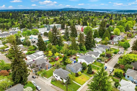 an aerial view of a house with a yard and lake view