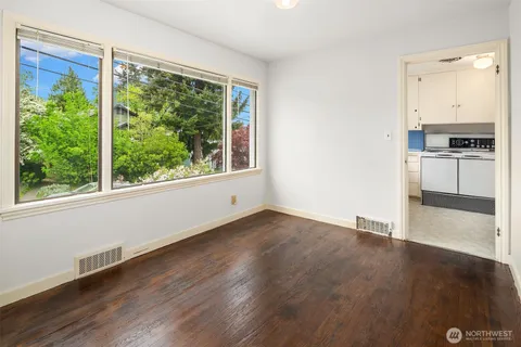 a view of a kitchen with a stove wooden floor and a window