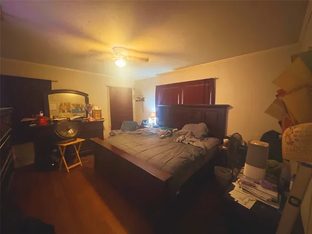 a bed sitting in a room next to a lamp