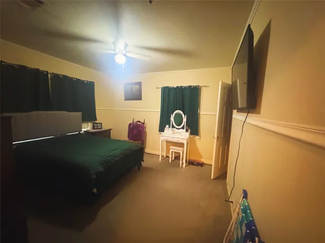 a bed room with a bed and a chair