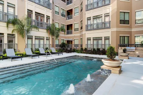 a view of a swimming pool with a lounge chair