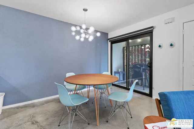 a view of a dining room with furniture and chandelier