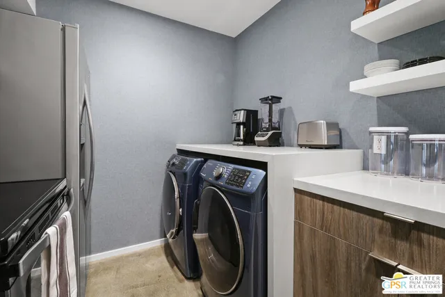 a utility room with sink dryer and washer