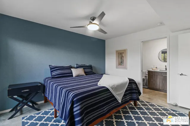 a bedroom with double bed and a dresser