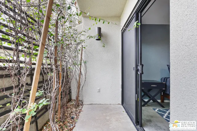 a view of a patio with table and chairs