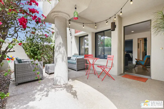 a living room with furniture and flowers