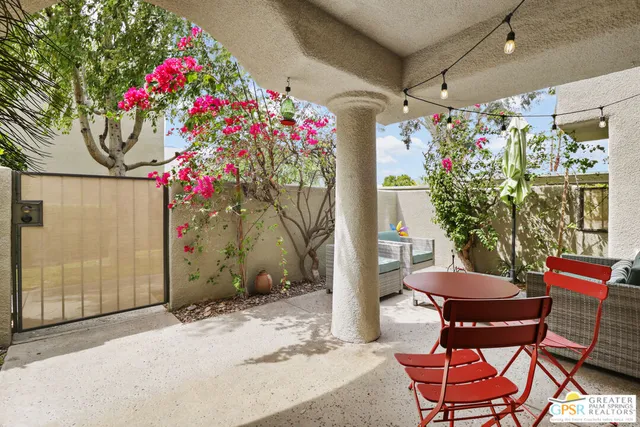 a front view of a house with yard and sitting area