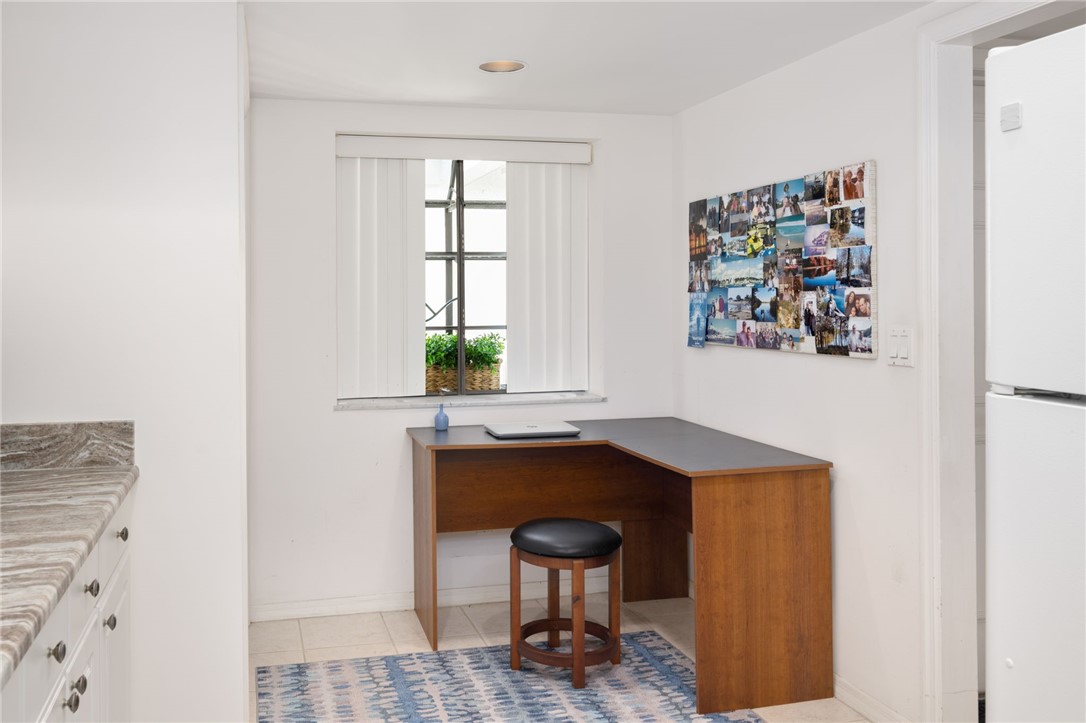 1870 Bay Road, Unit 213G Vero Beach, FL 32963 - Photo 11 of 36 a bathroom with a sink a chair and painting on the wall
