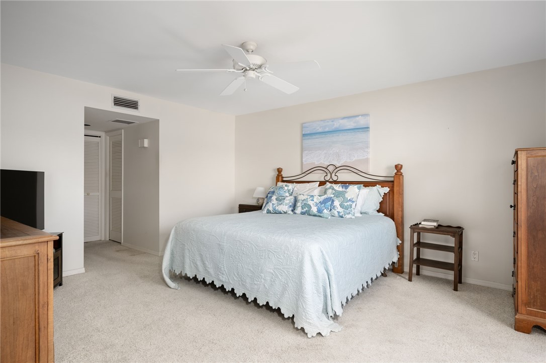 1870 Bay Road, Unit 213G Vero Beach, FL 32963 - Photo 16 of 36 a bedroom with bed and a flat tv screen on dresser
