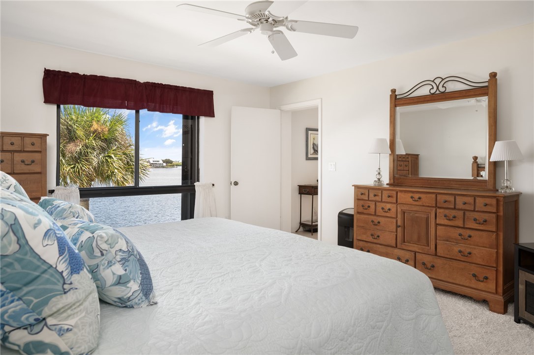 1870 Bay Road, Unit 213G Vero Beach, FL 32963 - Photo 17 of 36 a bedroom with a bed and a dresser