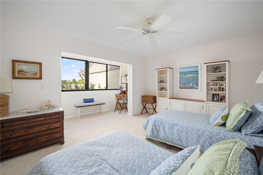 1870 Bay Road, Unit 213G Vero Beach, FL 32963 - Photo 20 of 36 a bedroom with a bed and a couch