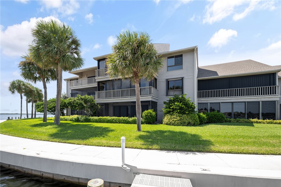 1870 Bay Road, Unit 213G Vero Beach, FL 32963 - Photo 24 of 36 a view of a building with a yard
