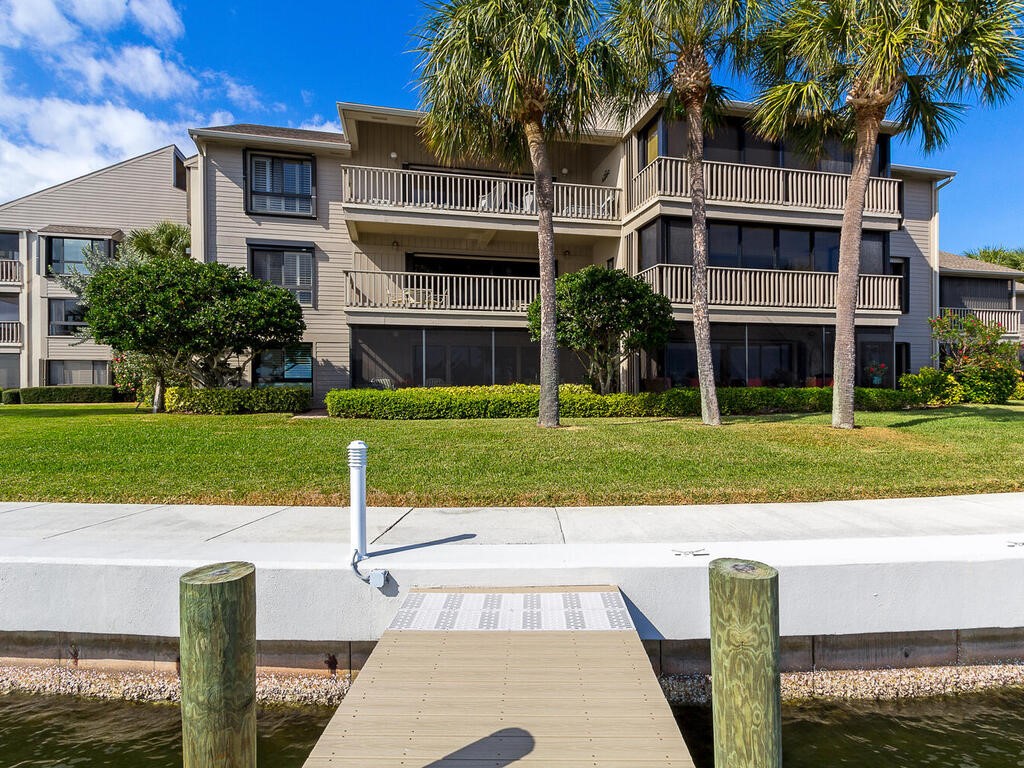 1870 Bay Road, Unit 213G Vero Beach, FL 32963 - Photo 25 of 36 a view of a building with a yard and plants