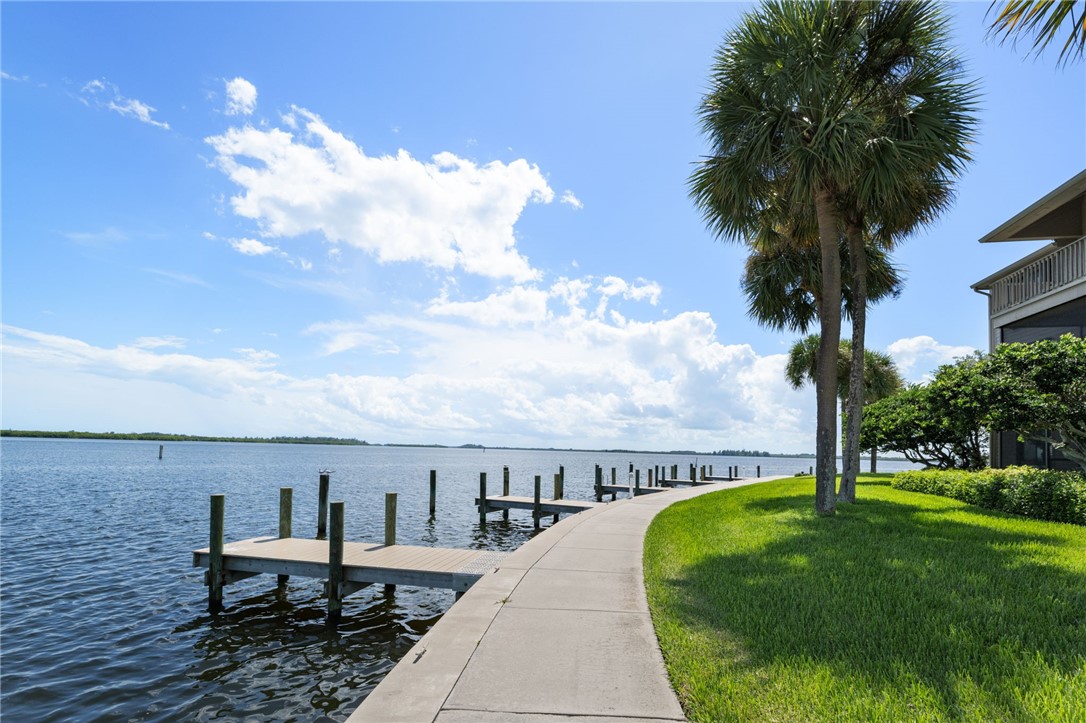 1870 Bay Road, Unit 213G Vero Beach, FL 32963 - Photo 27 of 36 a view of a swimming pool with an outdoor seating and a yard