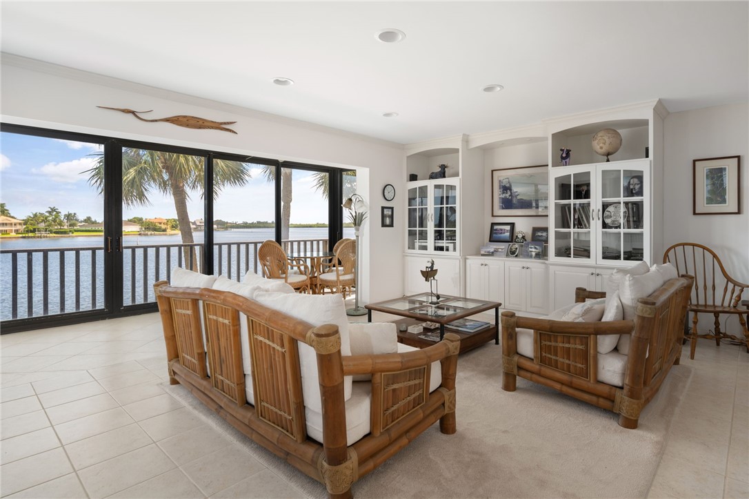 1870 Bay Road, Unit 213G Vero Beach, FL 32963 - Photo 3 of 36 a spacious bedroom with a bed and a large window