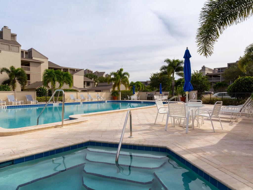 1870 Bay Road, Unit 213G Vero Beach, FL 32963 - Photo 31 of 36 a view of swimming pool with outdoor seating and a lake view