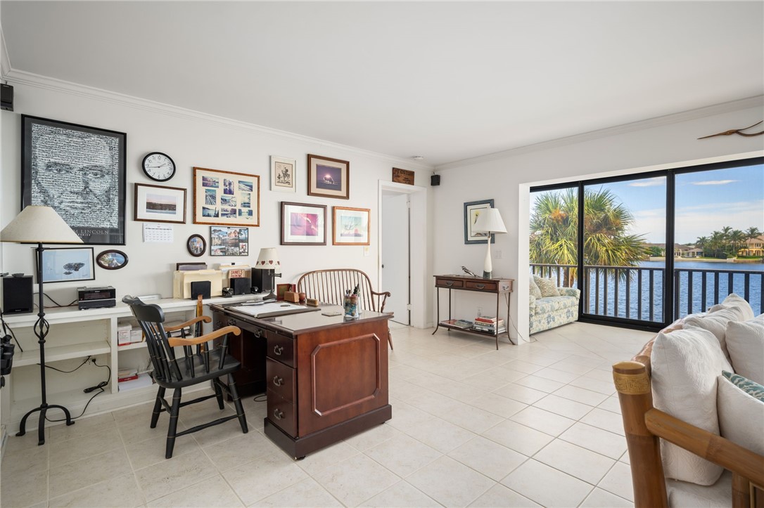 1870 Bay Road, Unit 213G Vero Beach, FL 32963 - Photo 7 of 36 a view of a livingroom with workspace and a window