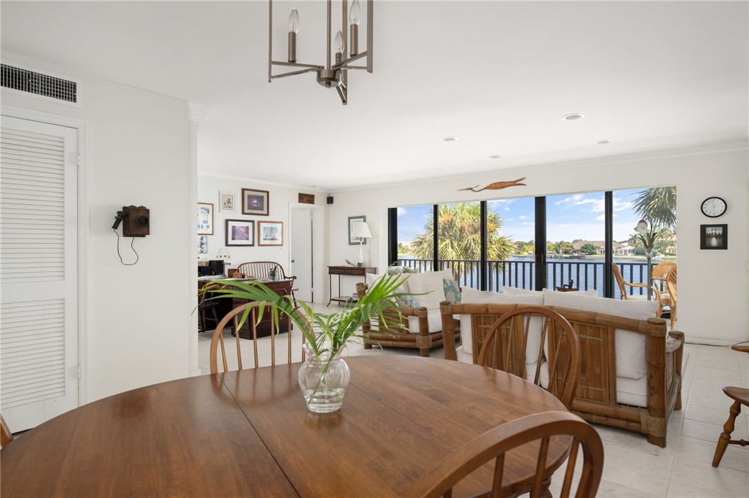 1870 Bay Road, Unit 213G Vero Beach, FL 32963 - Photo 8 of 36 a view of a dining room with furniture and floor to ceiling window
