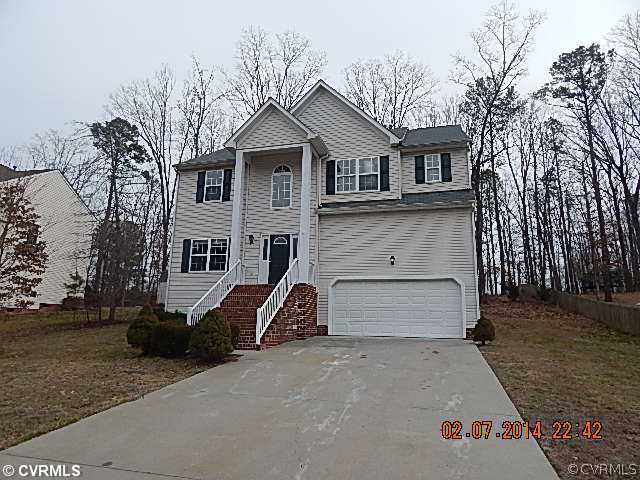 14724 Clover Ridge Lane Chesterfield, VA 23832 - Photo 1 of 7 a front view of a house with a yard and garage