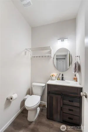 a bathroom with a toilet sink and mirror
