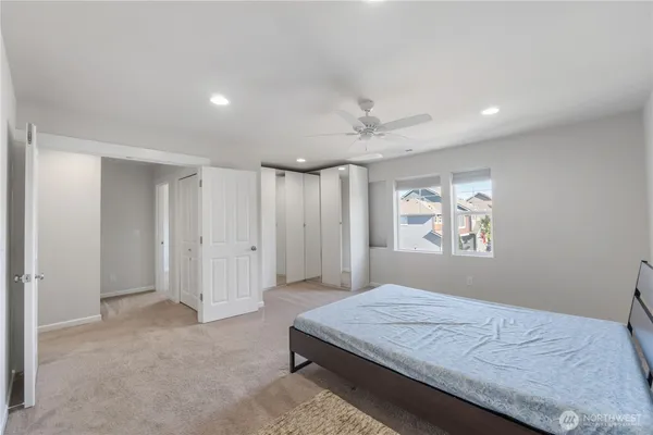 a bedroom with a bed and a window