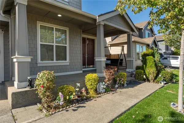 a front view of a house with a yard outdoor seating and flowers