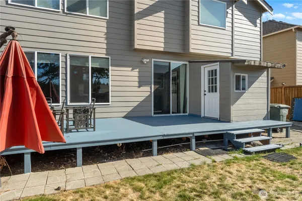 a view of a house with yard and sitting area