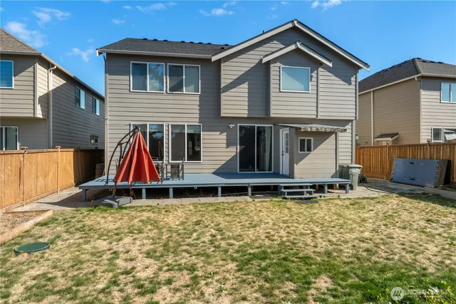 a backyard of a house with table and chairs