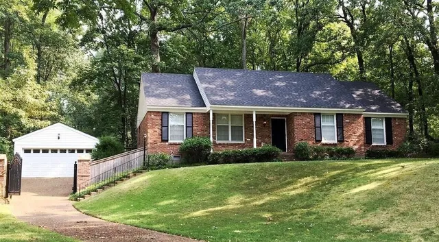 a front view of a house with garden