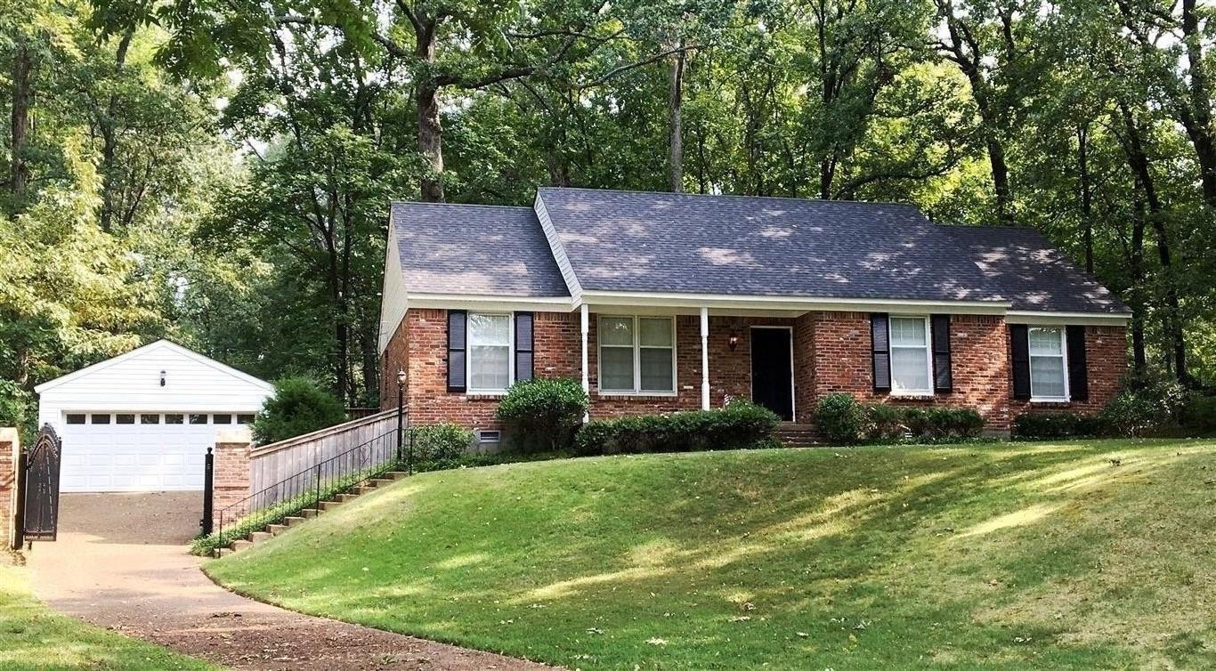 5482 North Rolling Oaks Drive Memphis, TN 38119 - Photo 1 of 4 a front view of a house with garden