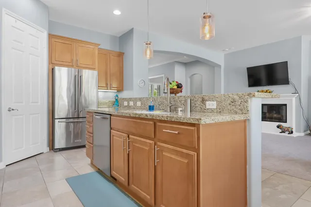 a kitchen with stainless steel appliances granite countertop a refrigerator sink and microwave