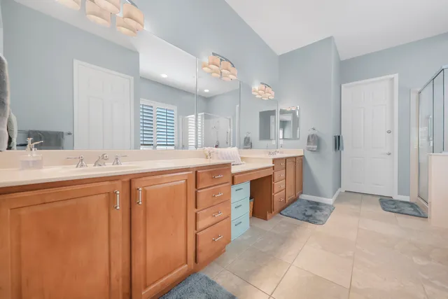 a spacious bathroom with a sink double vanity and a mirror