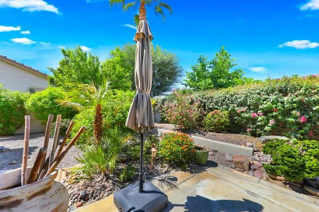 a view of a patio with couches table and chairs and potted plants