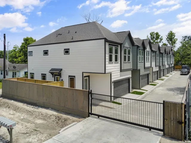 a view of a house with wooden fence