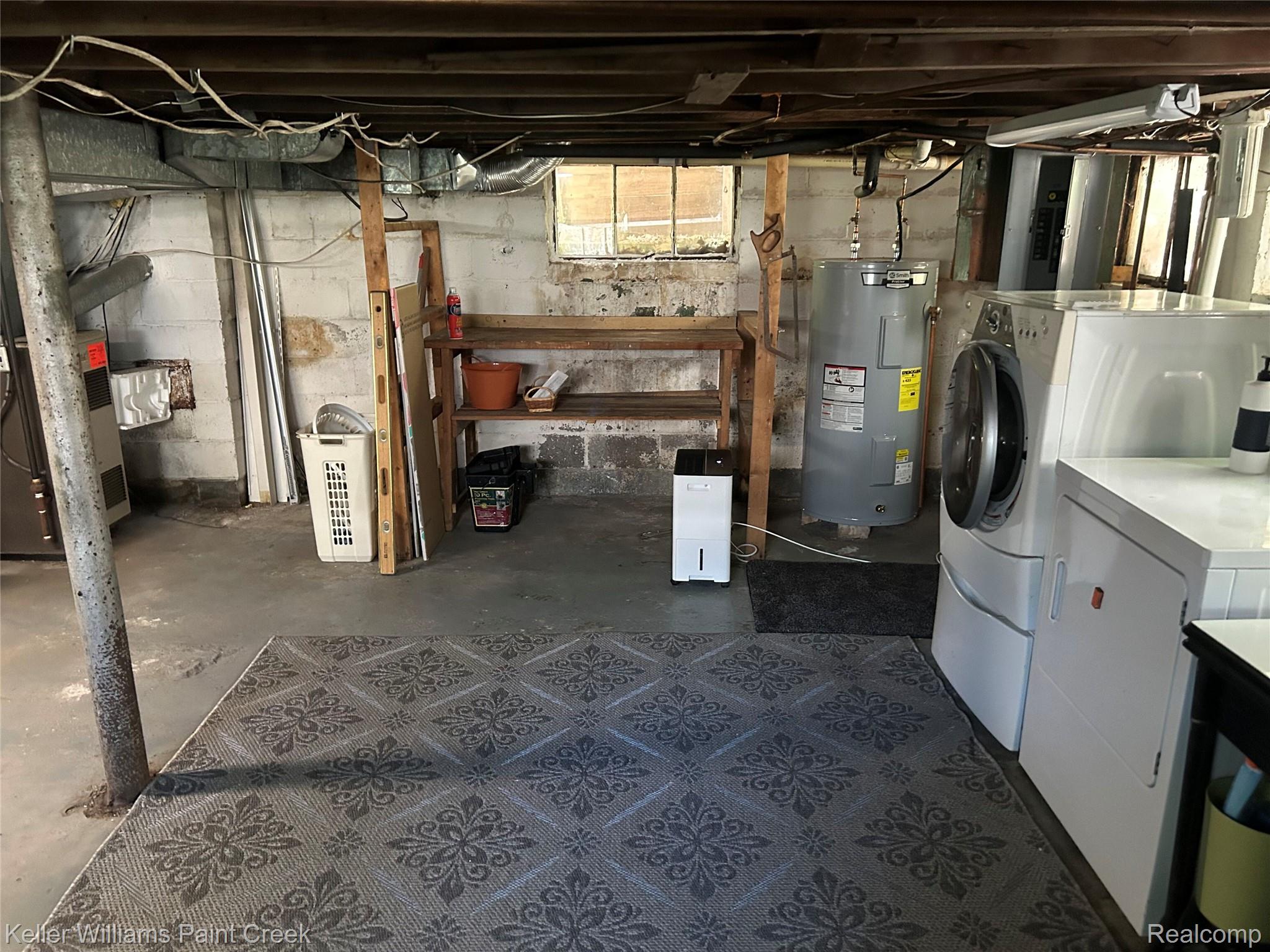 227 Ora Road Oxford, MI 48371 - Photo 39 of 60 Utility area featuring a water heater, washer, and dryer