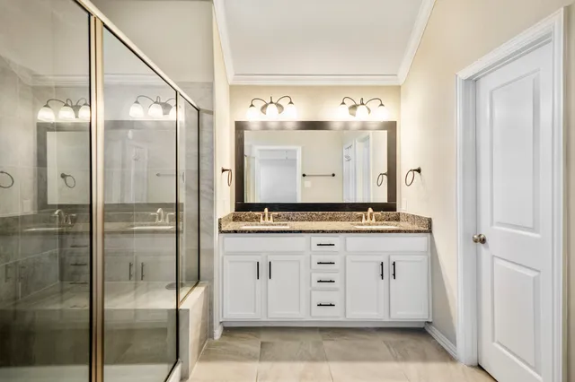 a bathroom with a granite countertop sink mirror and a