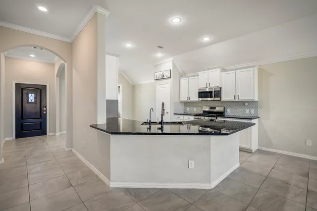 a kitchen with stainless steel appliances granite countertop a sink and cabinets