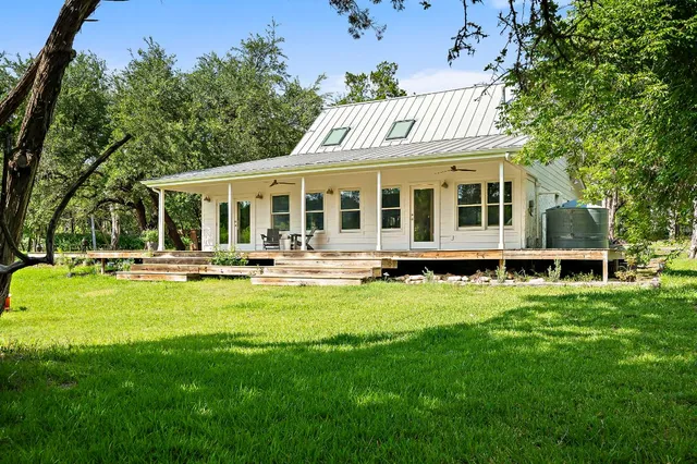 a view of a house with swimming pool and porch with furniture