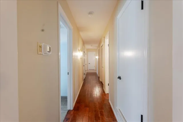 a view of a hallway with wooden floor