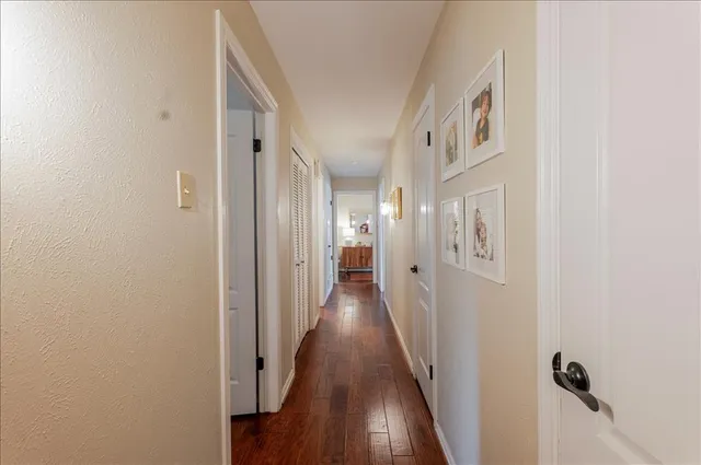 a view of a hallway with wooden floor