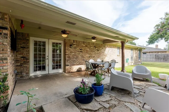 a view of a patio with couches chairs and potted plants