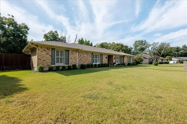 a front view of house with yard and swimming pool