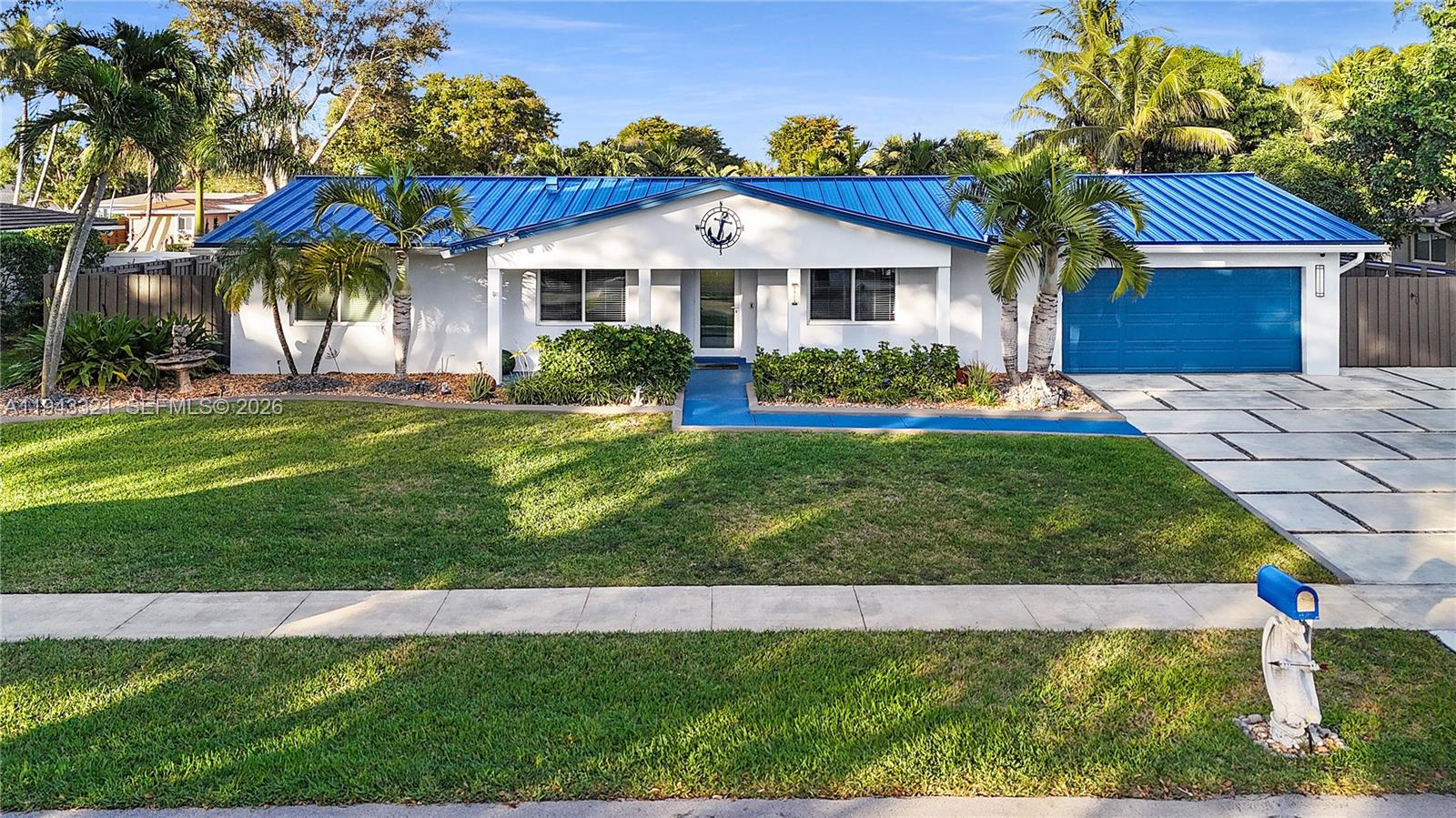 5921 Southwest 17th Street Plantation, FL 33317 - Photo 1 of 53 a front view of a house with a yard