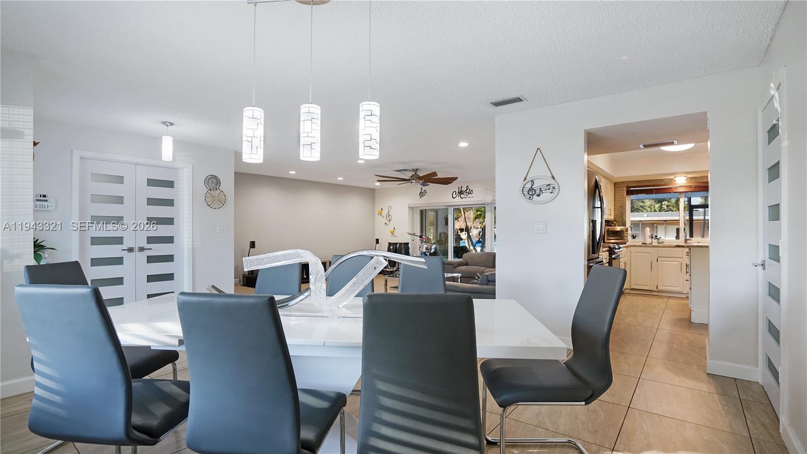 5921 Southwest 17th Street Plantation, FL 33317 - Photo 12 of 53 a dining room with furniture a large window and wooden floor