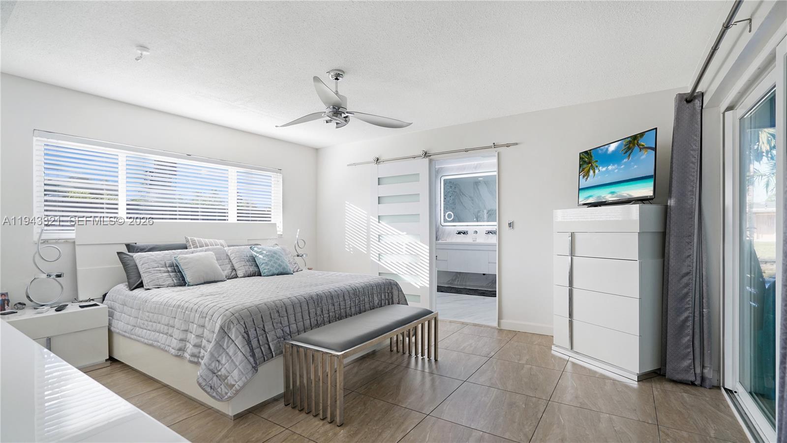 5921 Southwest 17th Street Plantation, FL 33317 - Photo 18 of 53 a bedroom with a bed and a television