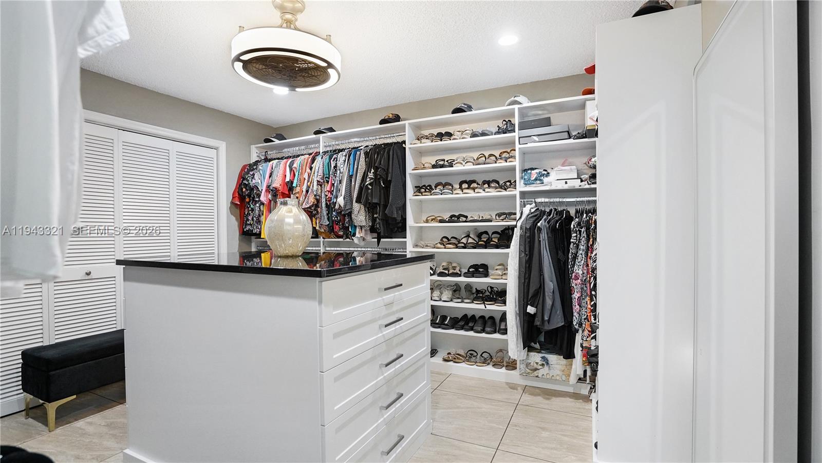 5921 Southwest 17th Street Plantation, FL 33317 - Photo 23 of 53 a view of walk in closet with clothes and shoes