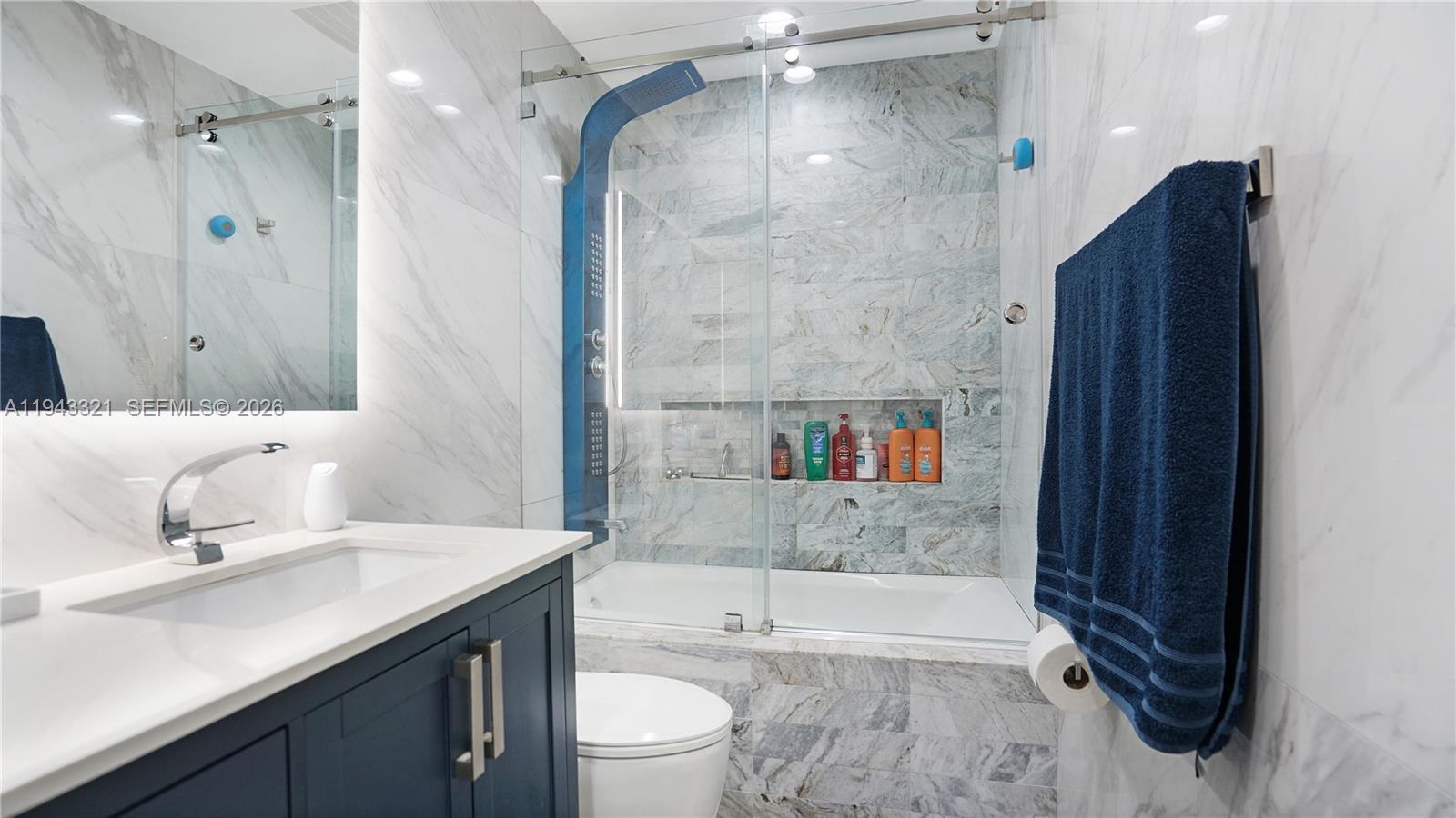 5921 Southwest 17th Street Plantation, FL 33317 - Photo 30 of 53 a bathroom with a bathtub shower sink vanity and toilet