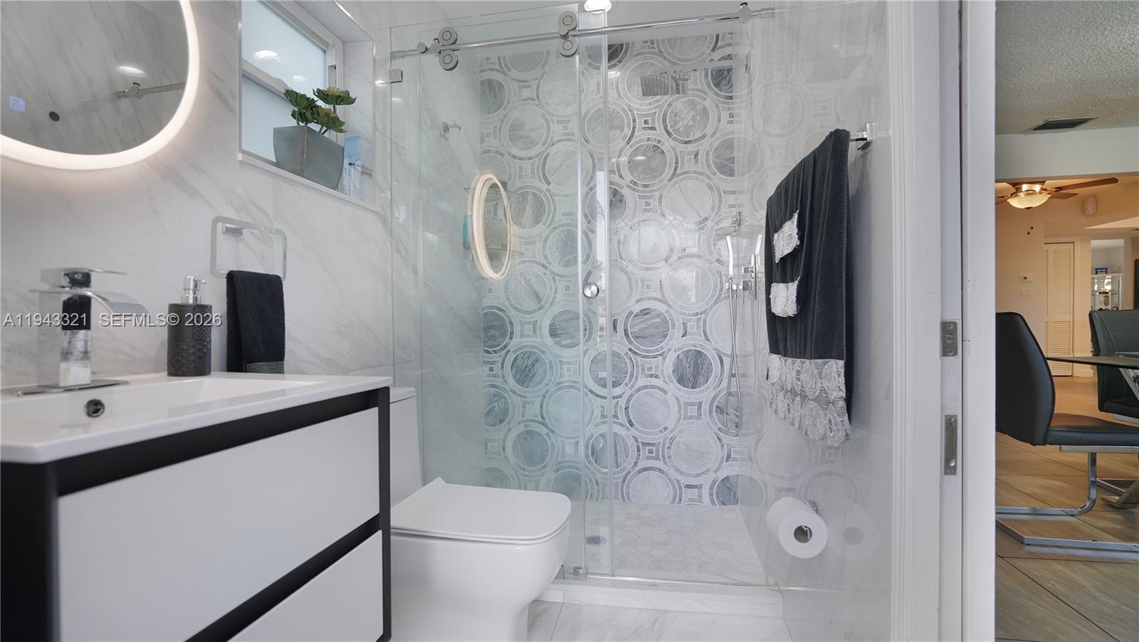 5921 Southwest 17th Street Plantation, FL 33317 - Photo 36 of 53 a bathroom with a sink a toilet and shower