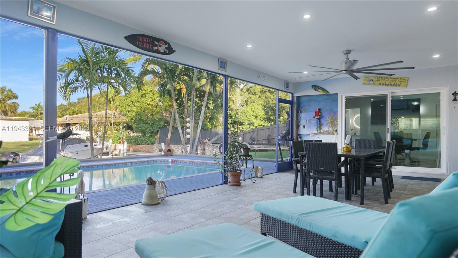 5921 Southwest 17th Street Plantation, FL 33317 - Photo 38 of 53 a living room with fireplace furniture and a large window